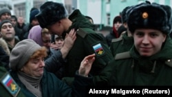 Russian conscripts called up for military service say goodbye to relatives at a railway station in Omsk in November 2022. 