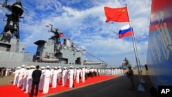 Officers from China's People's Liberation Army (PLA) hold a welcome ceremony as a Russian naval ship arrives in Zhanjiang in southern China in 2016.