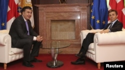 Georgian President Mikheil Saakashvili (left) sits across from Prime Minister Bidzina Ivanishvili during their meeting in Tbilisi on March 4.