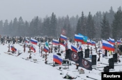 Flags fly over the graves of Russian soldiers at a cemetery in St. Petersburg on February 12.