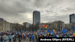 Ralliers wave flags at a demonstration of solidarity with "European values" in Bucharest on March 15.