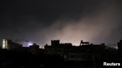 Dust rises from the site of US strikes in Sanaa, the Yemeni capital, on March 15.